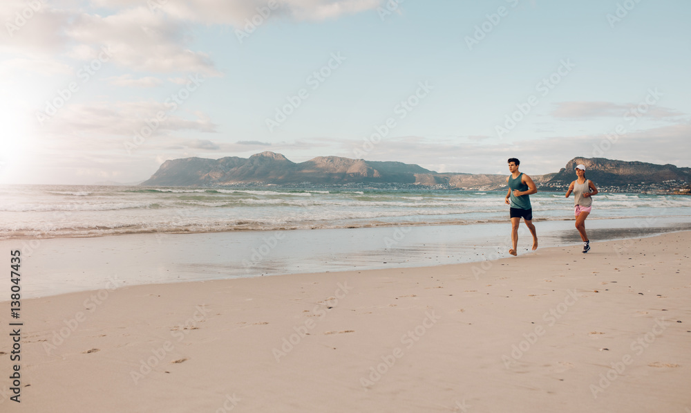 Couple on morning run at the beach