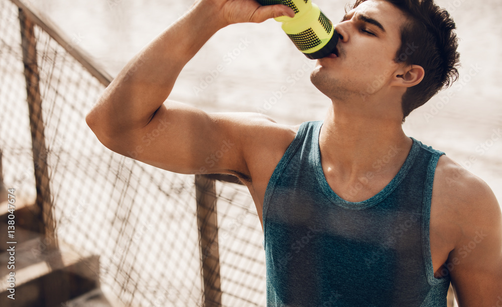 Man drinking water after running workout