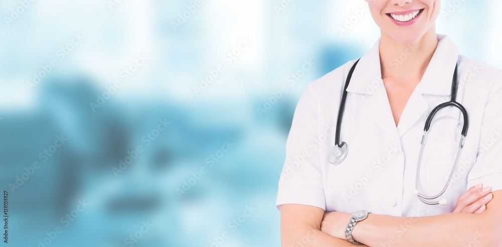 Composite image of happy doctor smiling at camera behind bed