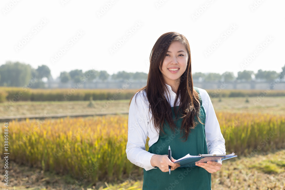 pretty asian woman in golden cereal field