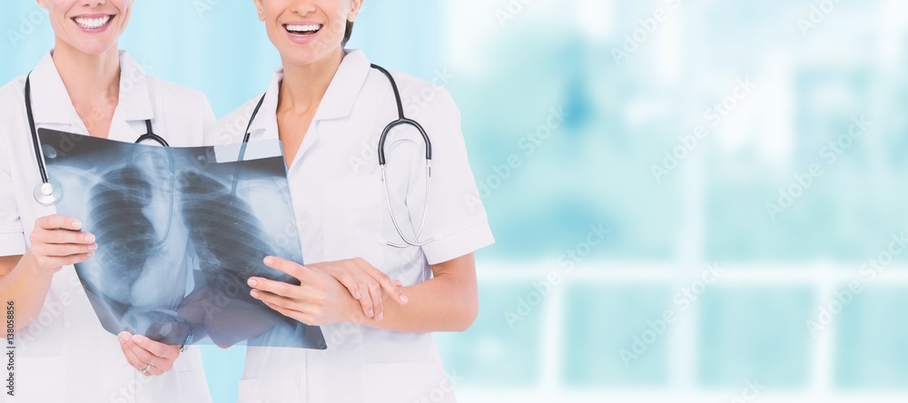 Composite image of smiling nurses with xray