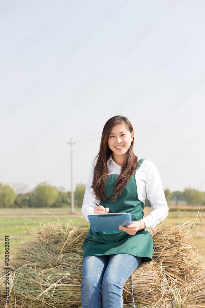 young asian woman agronomist in golden field