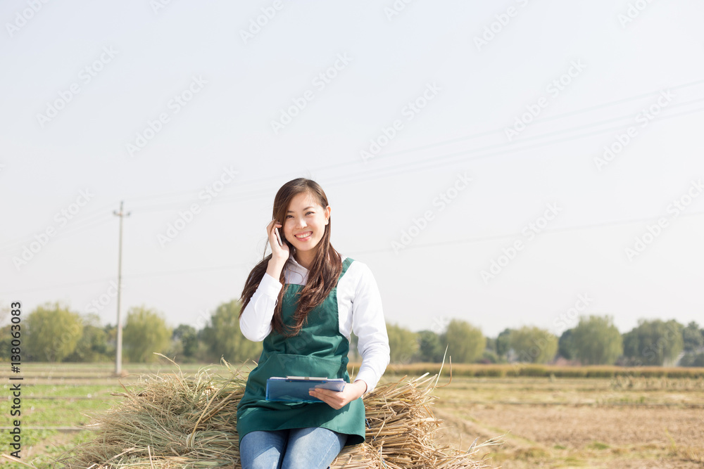 young asian woman agronomist in golden field