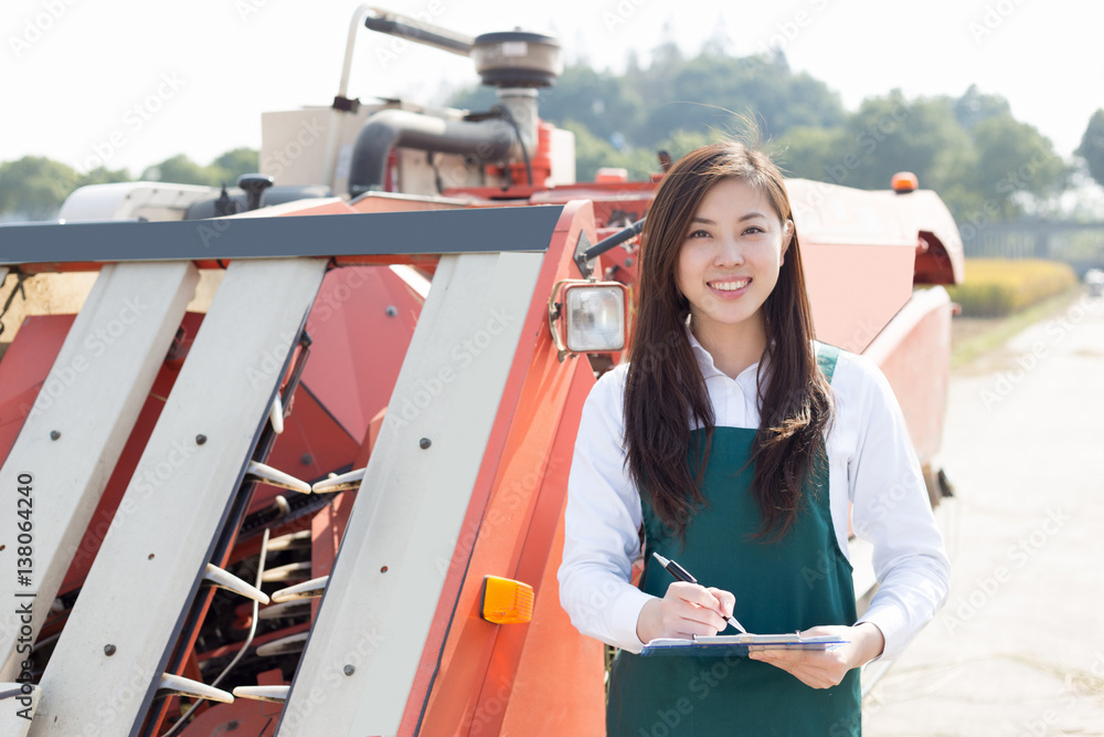 young asian woman agronomist in golden field