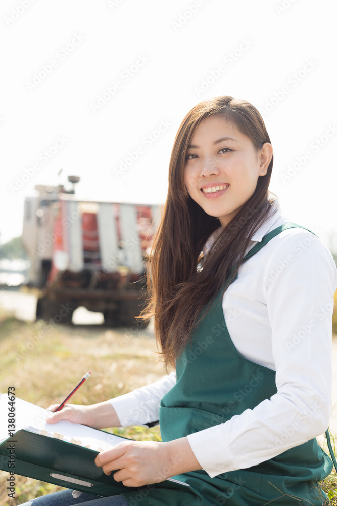 young asian woman agronomist in golden field