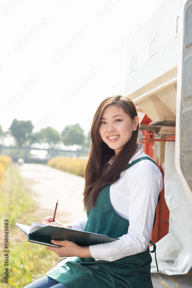 young asian woman agronomist in golden field