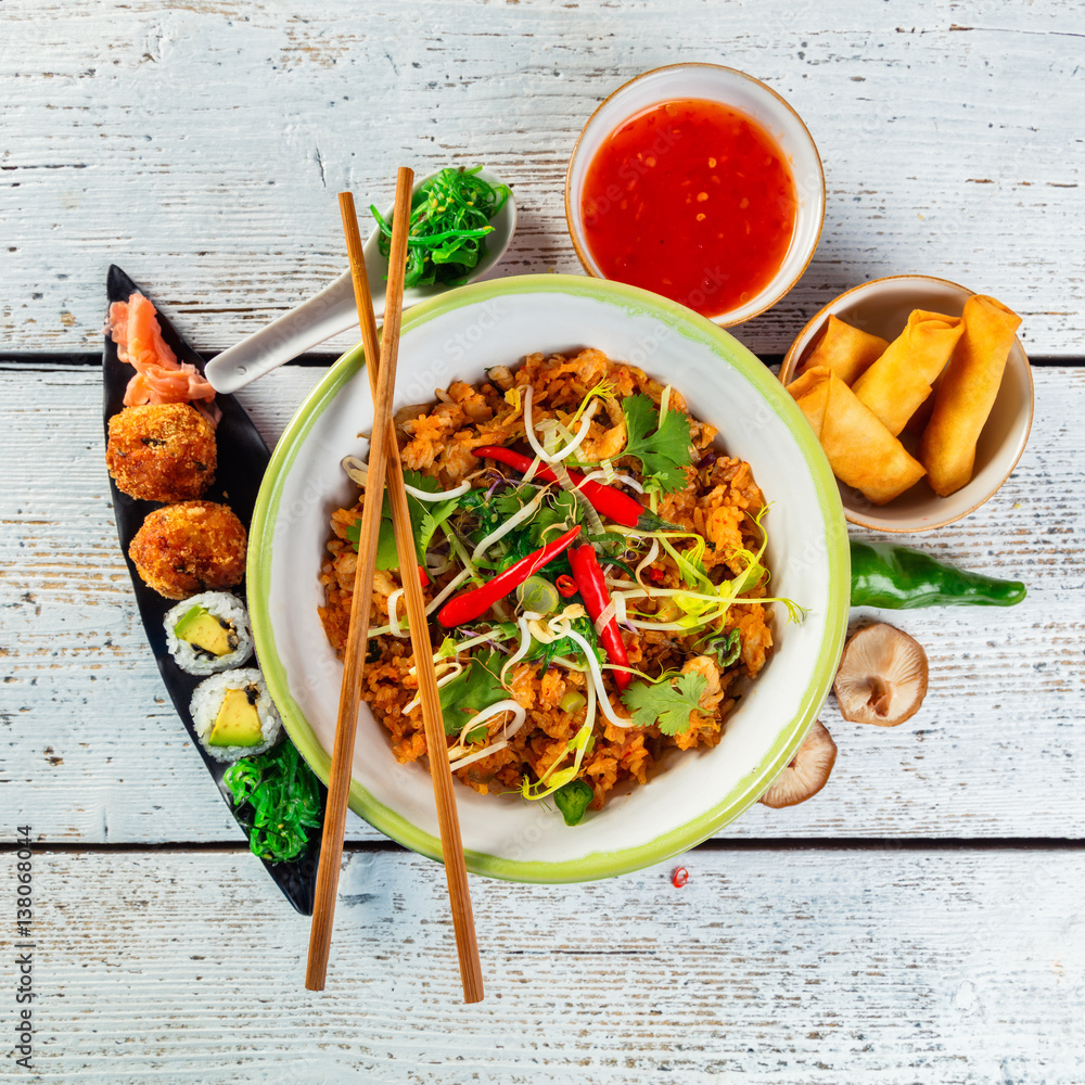 Asian chicken curry and prawns with rice and sushi pieces