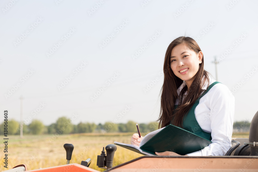 young asian woman agronomist in golden field