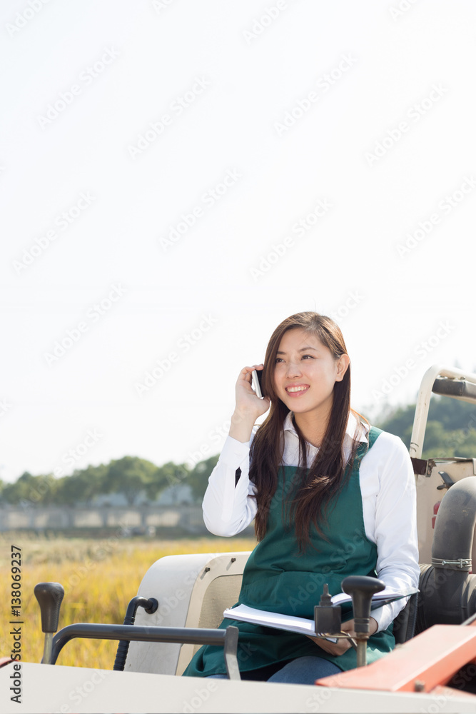 young asian woman agronomist in golden field