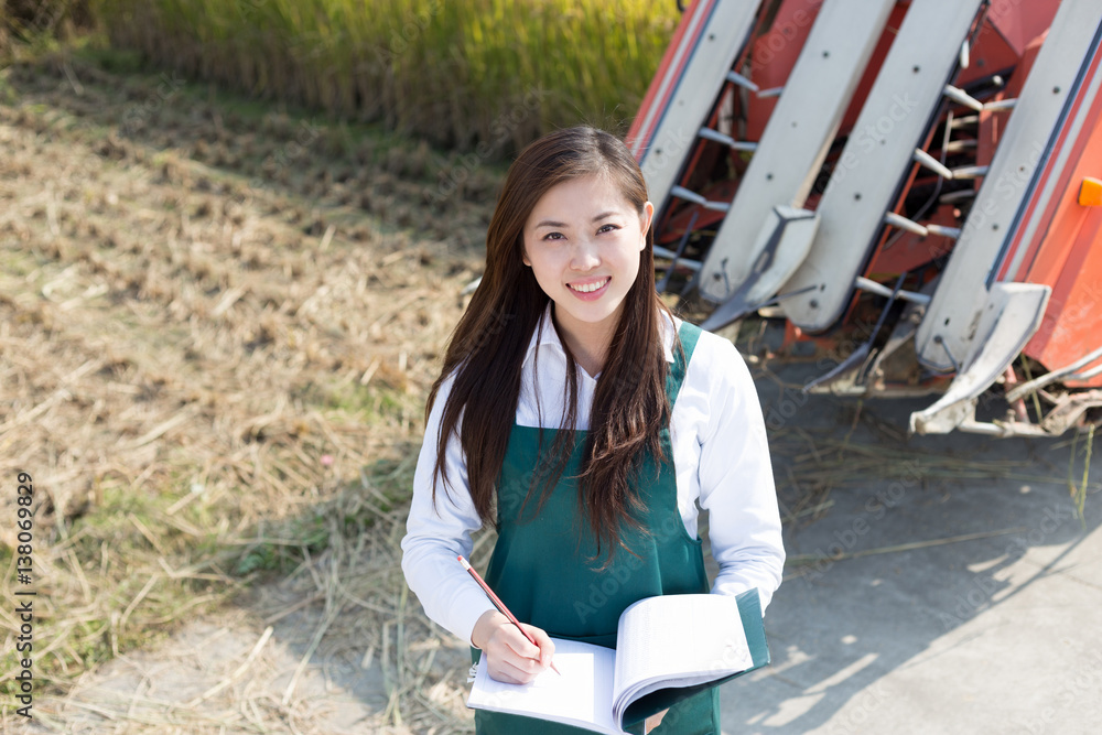 young asian woman agronomist in golden field