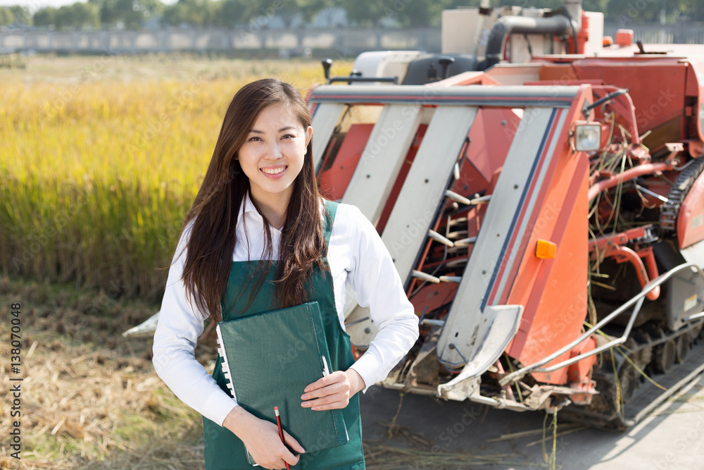 young asian woman agronomist in golden field