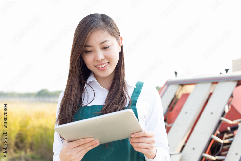 young asian woman agronomist in golden field