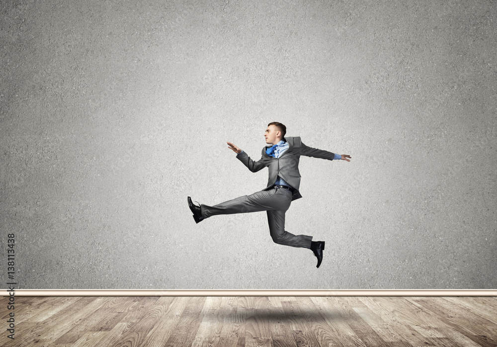 Businessman jumping high