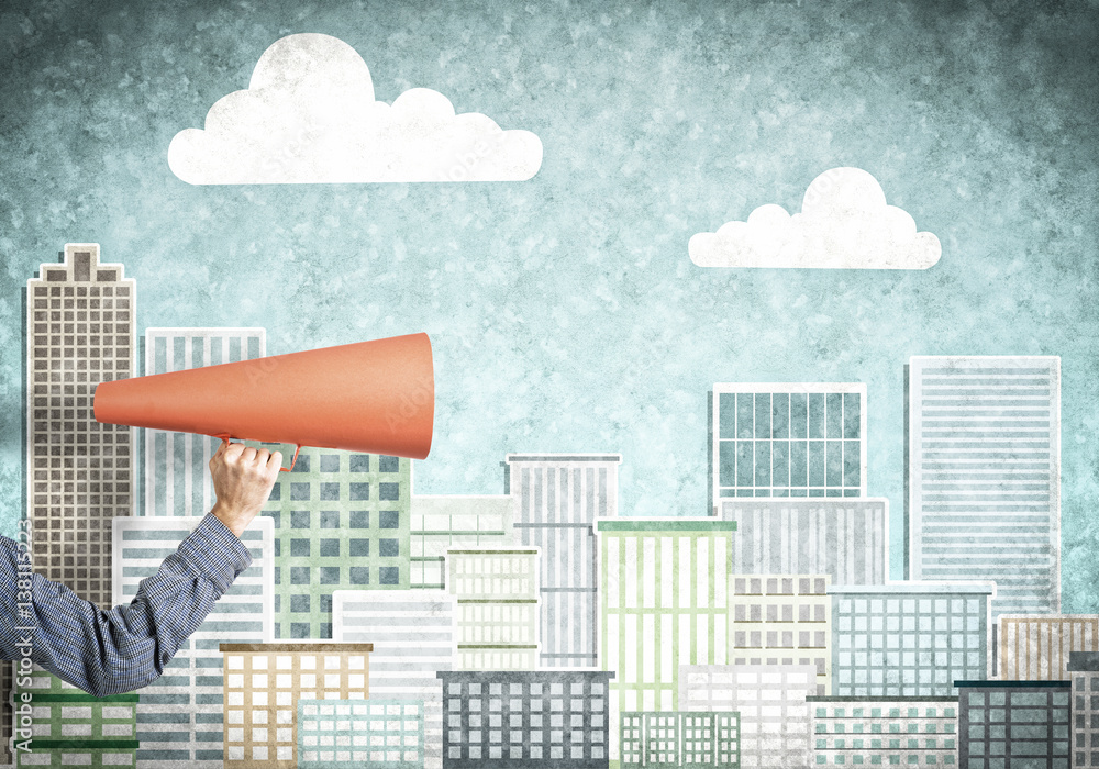 Hand of man holding orange paper trumpet against illustrated background