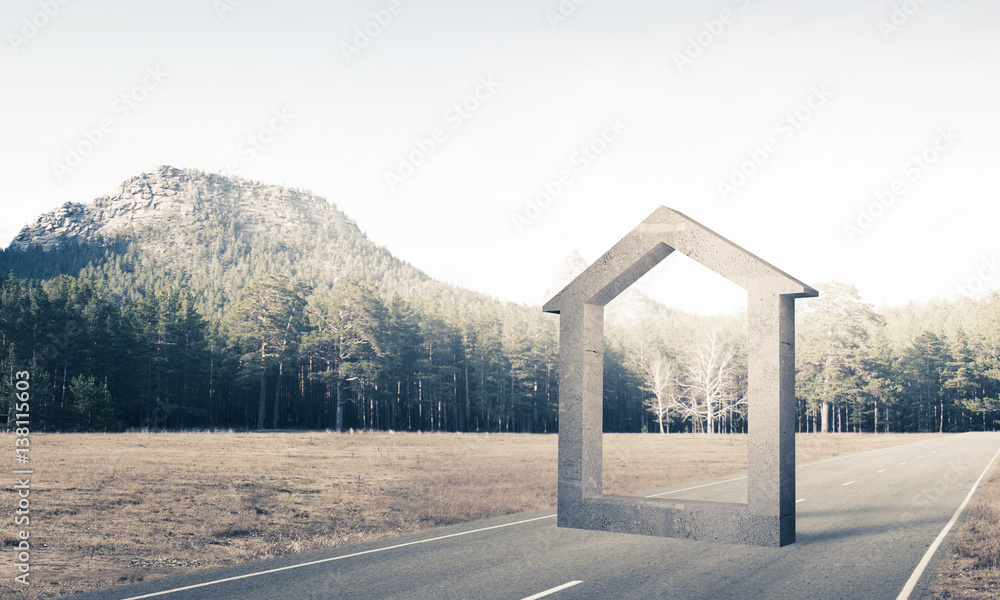 Conceptual background image of concrete home sign on asphalt roa