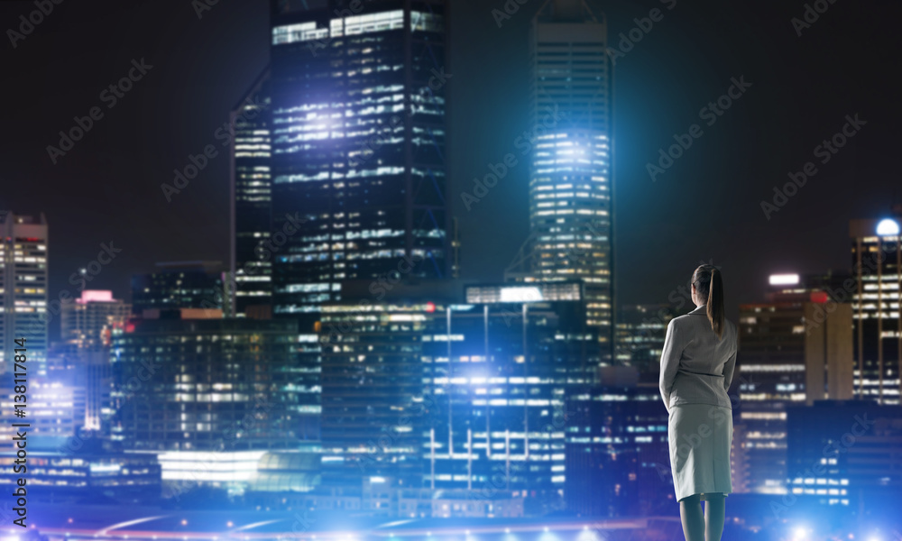 Woman looking at night city