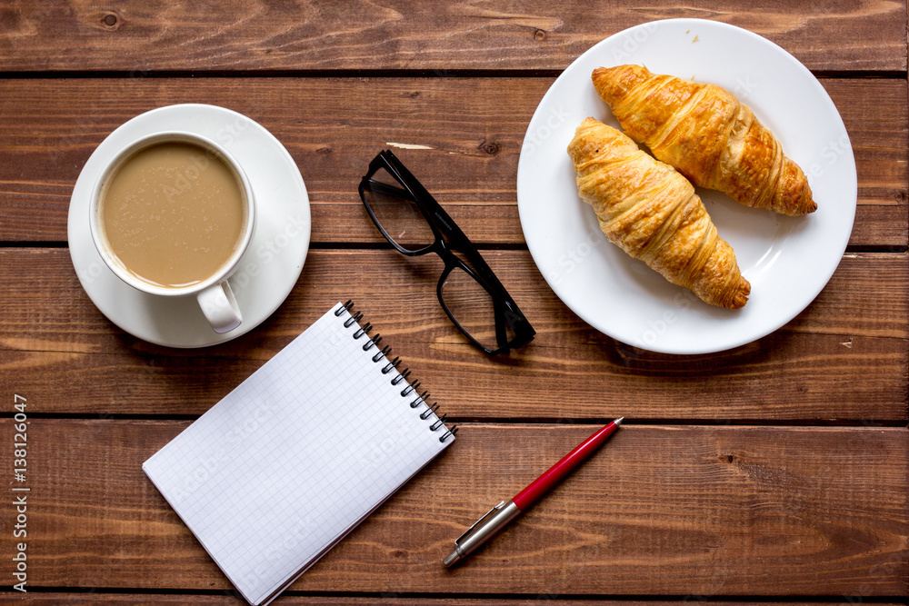 Business breakfast with coffee and croussant top view