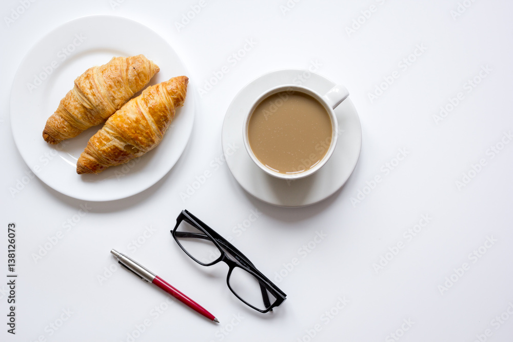 Business lunch with croissant on white table top view