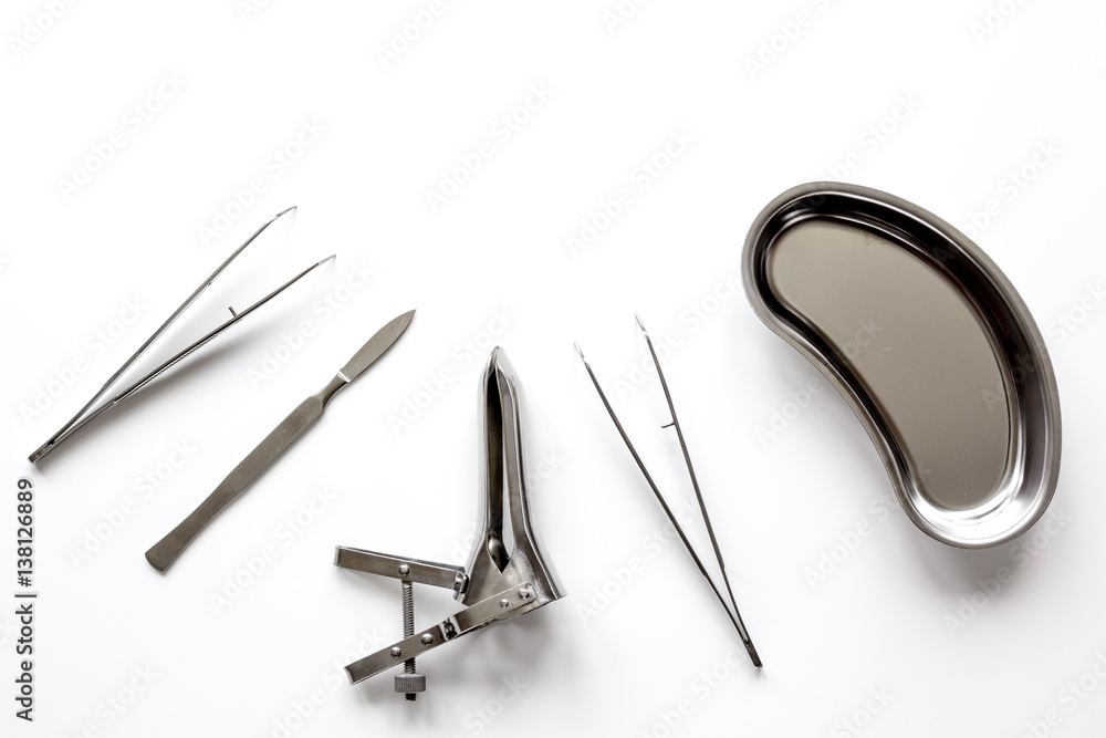 instruments of gynecologist on white background top view