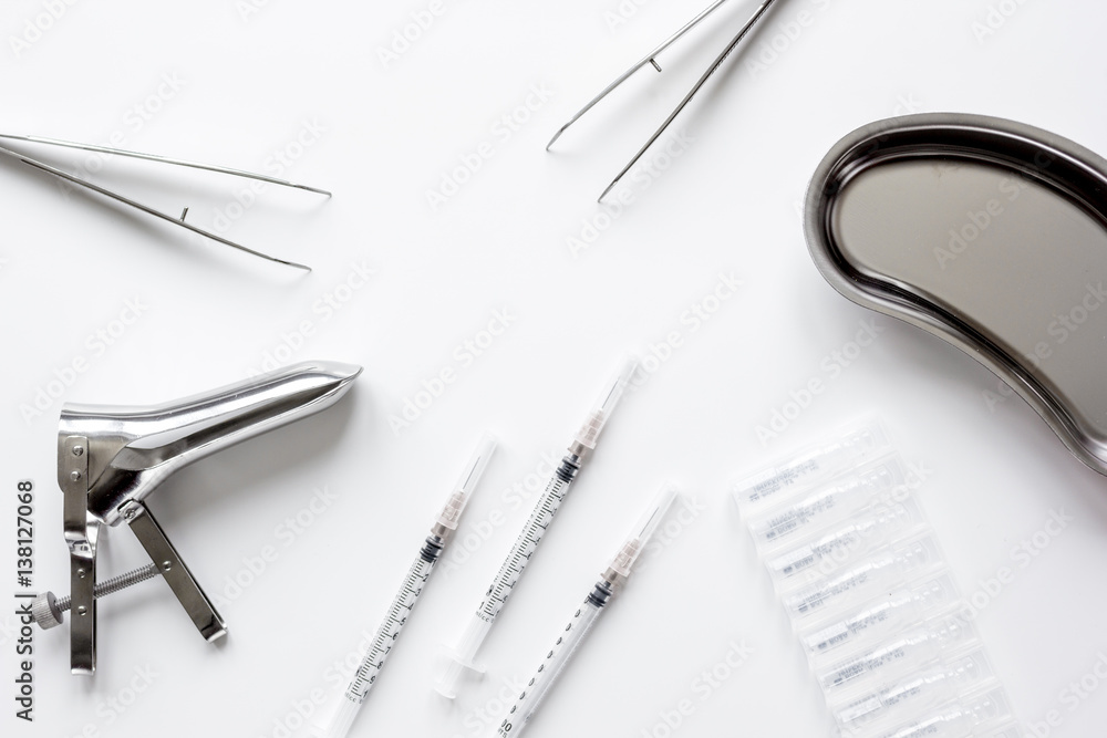 instruments of gynecologist on white background top view mock up