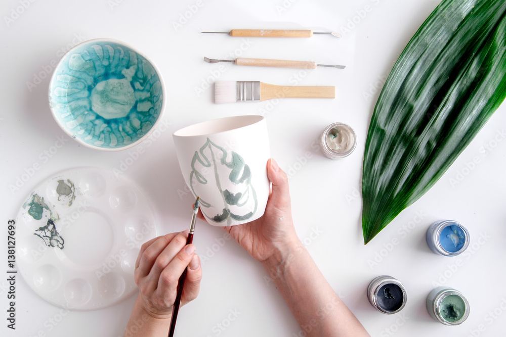 painted ceramic cup on white background top view