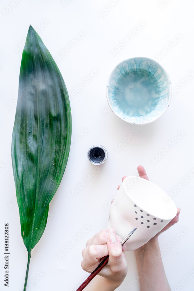 painted ceramic cup on white background top view