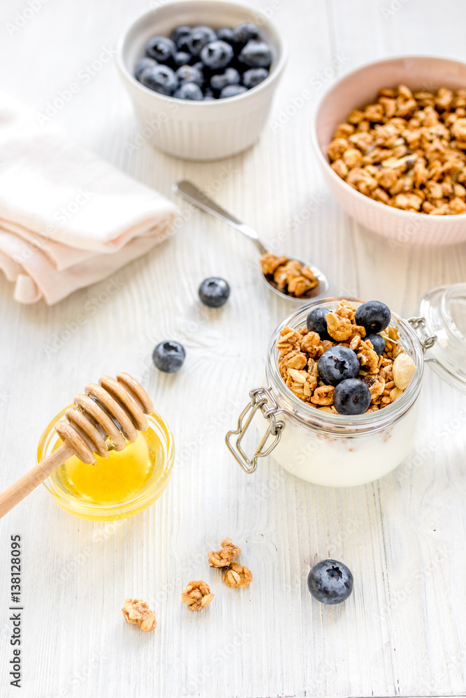 Fitness breakfast with granola and honey on white background