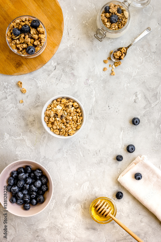 Oat flakes and berries granola glass on table background top view