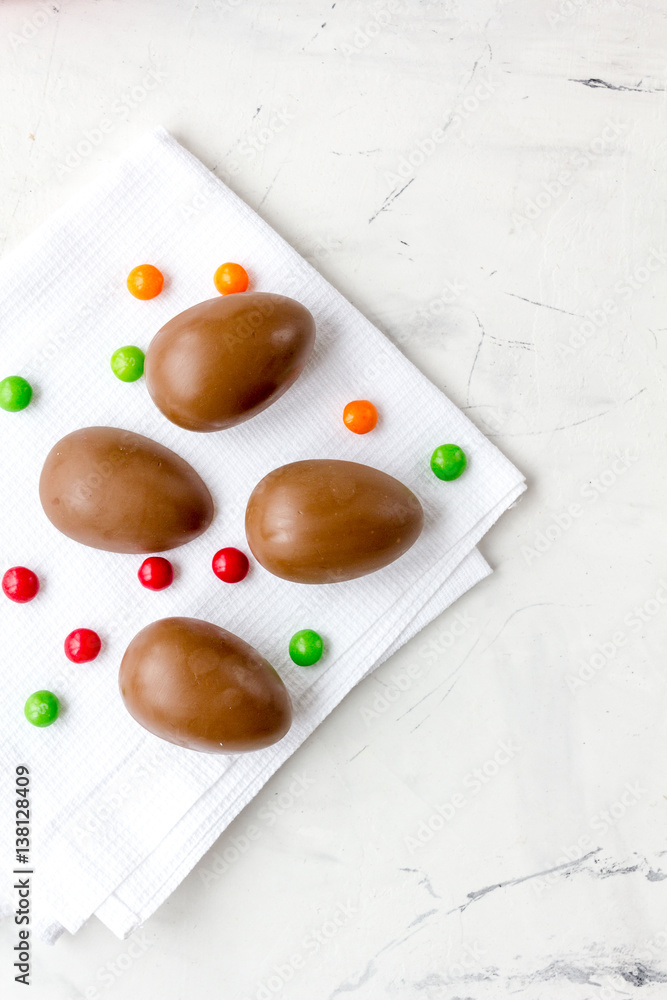 Easter chocolate eggs top view on stone background mock up