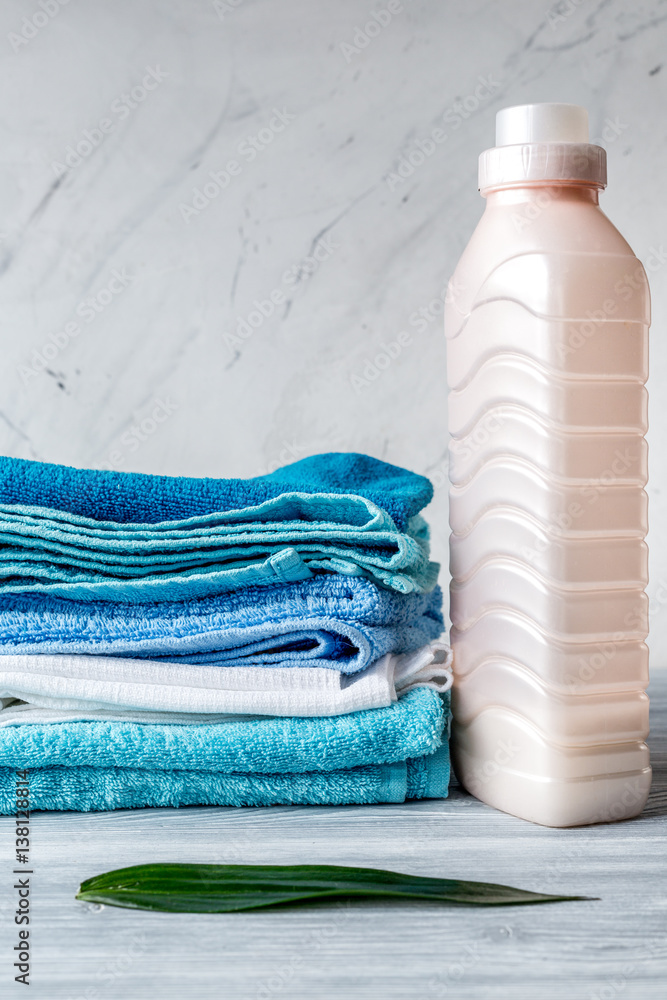 laundry set with towels and plastic bottels on gray background mock up