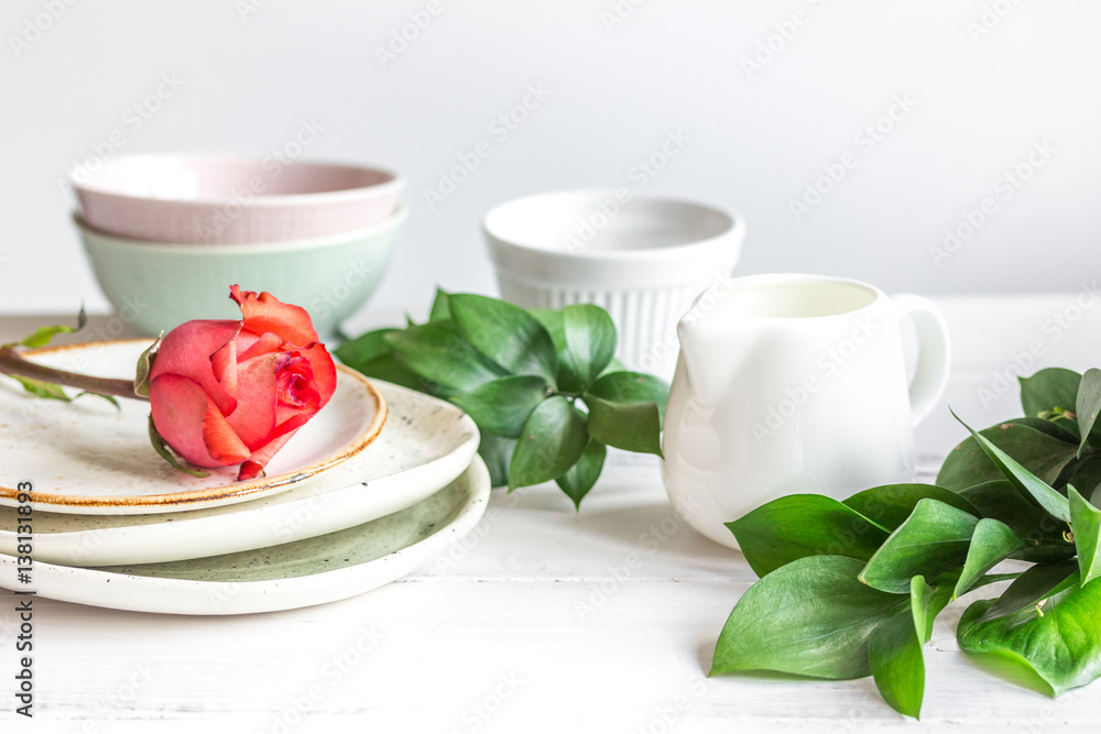 ceramic tableware with flowers on white background