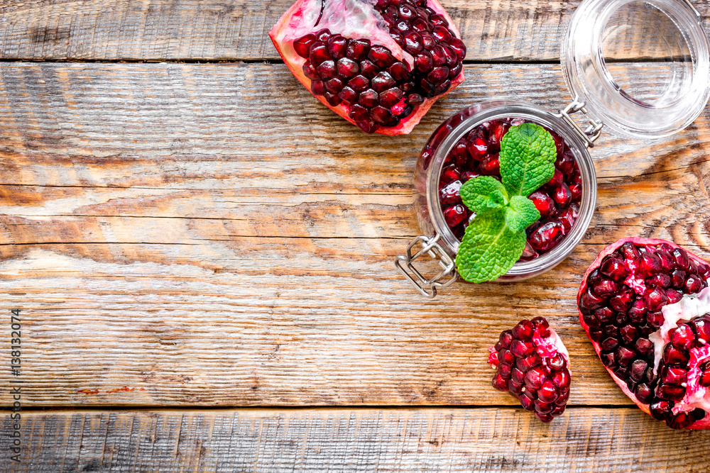 sliced pomegranate on wooden background top view