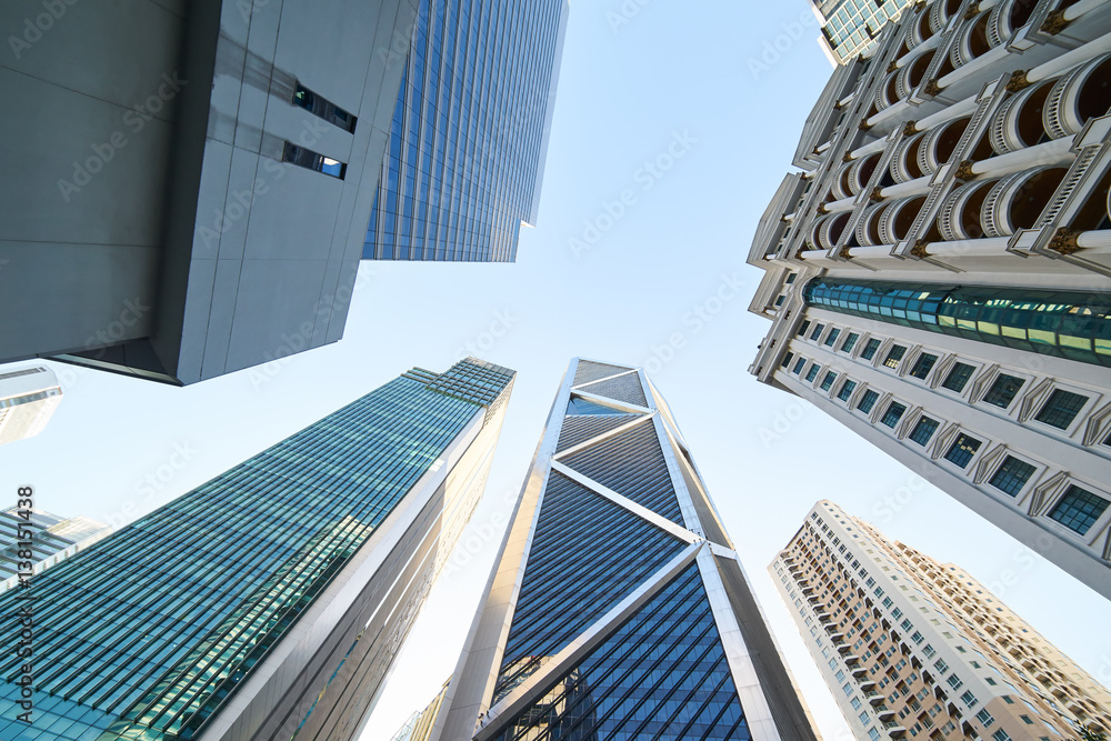 Low angle shot of modern glass city buildings with clear sky background. KL,Malaysia.