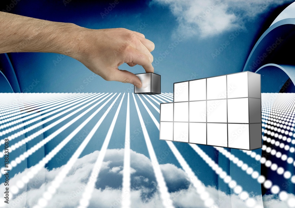 Composite image of Hand holding futuristic blocks against sky