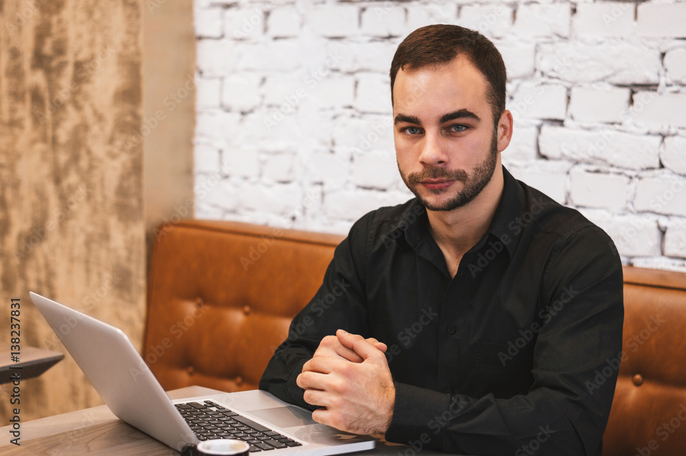 Authentic image of a businessman working in a coffee shop