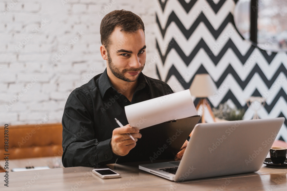 Businessman reading the paper reported in a coffee shop.