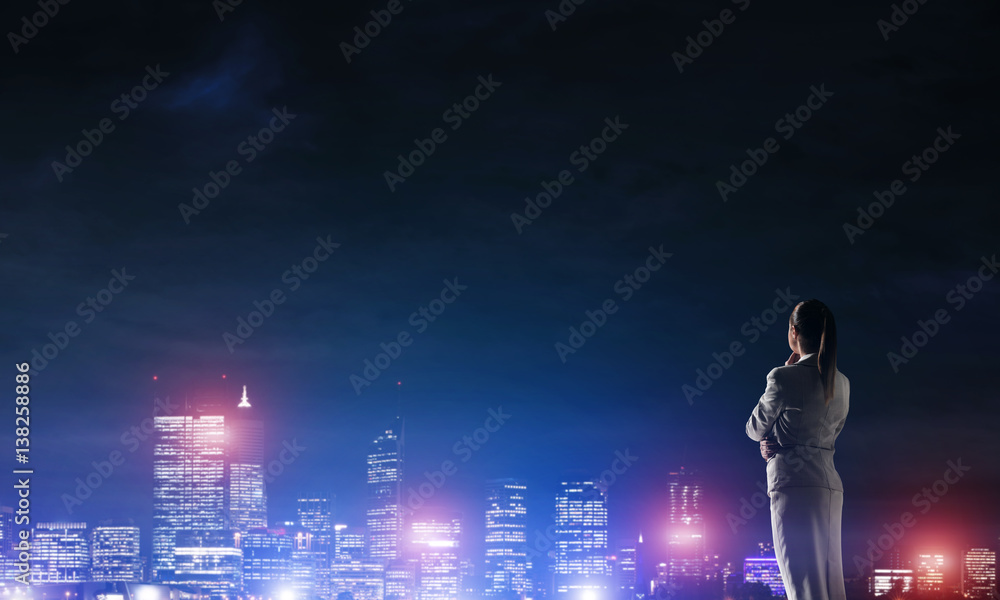 Woman looking at night city