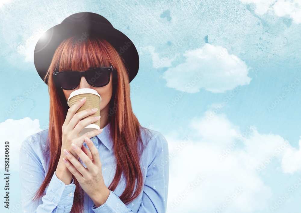 Woman with coffee against sky with flare background