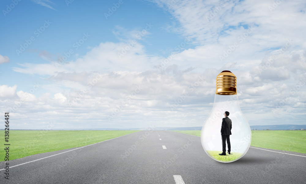 Businessman inside light bulb