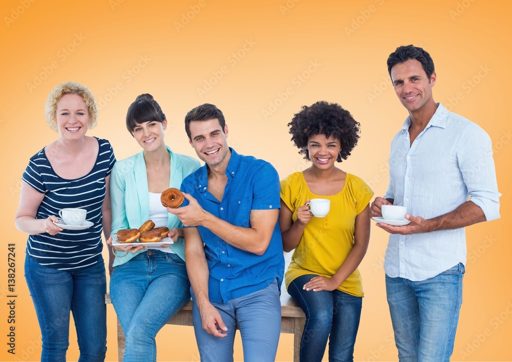 Happy group of people Eating donus against orange background