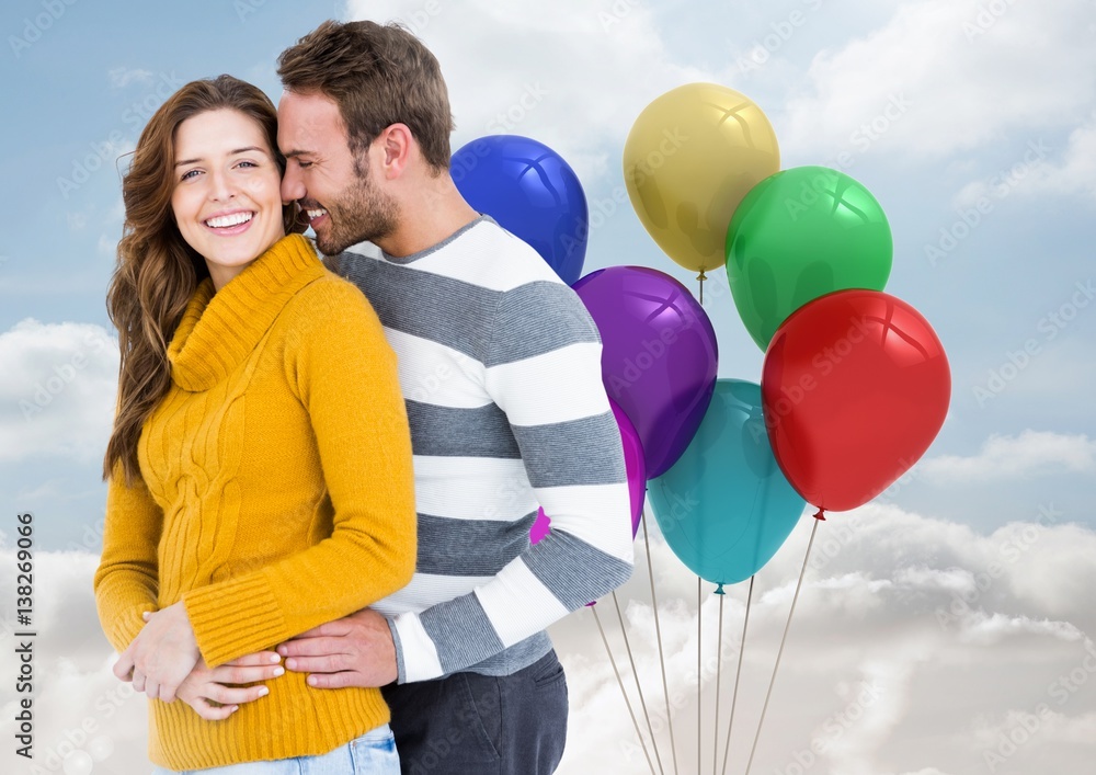 Happy couple with balloons against a sky background