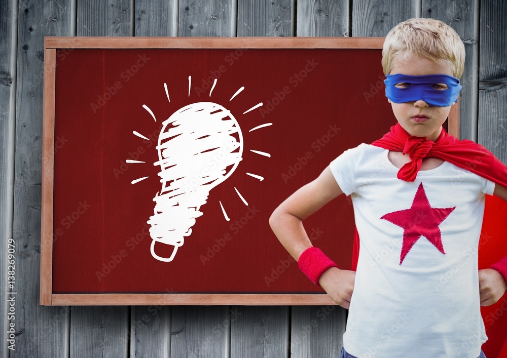 kid and blackboard with lightbulb against a wood background