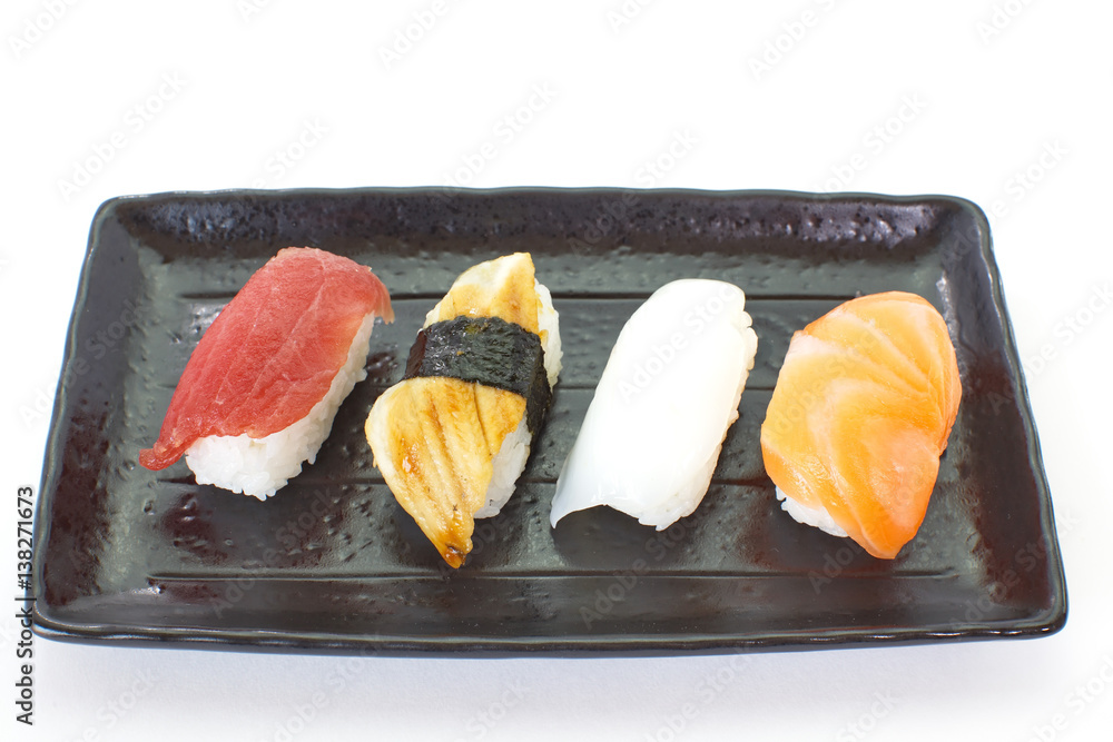 Japanese sushi raw seafood, vegetables and serving of cooked vinegared rice on white table backgroun