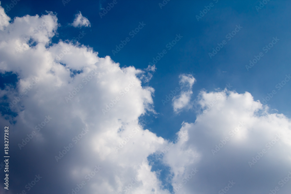 sun with sunbeams in a beautiful cloudy sky. blue sky is covered by white clouds