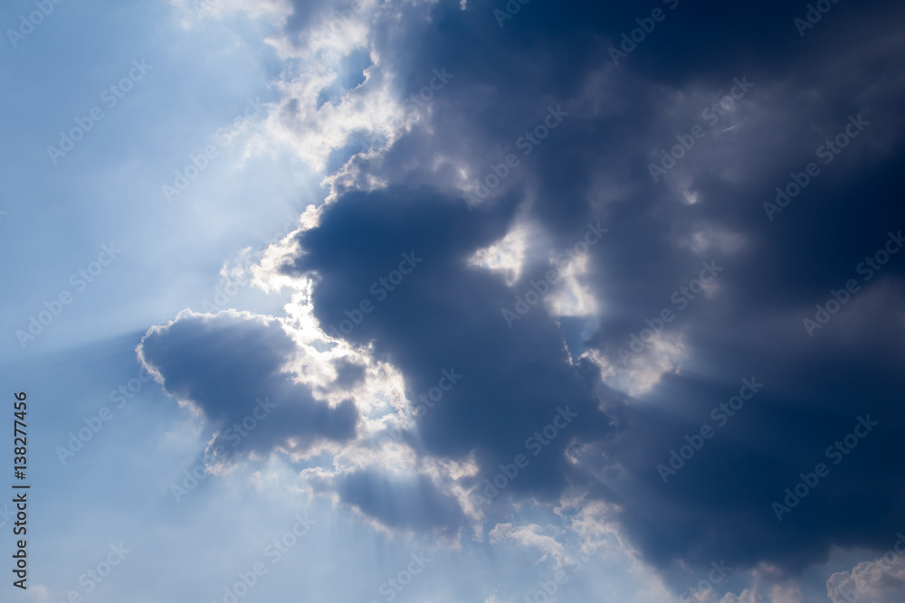 sun with sunbeams in a beautiful cloudy sky. blue sky is covered by white clouds