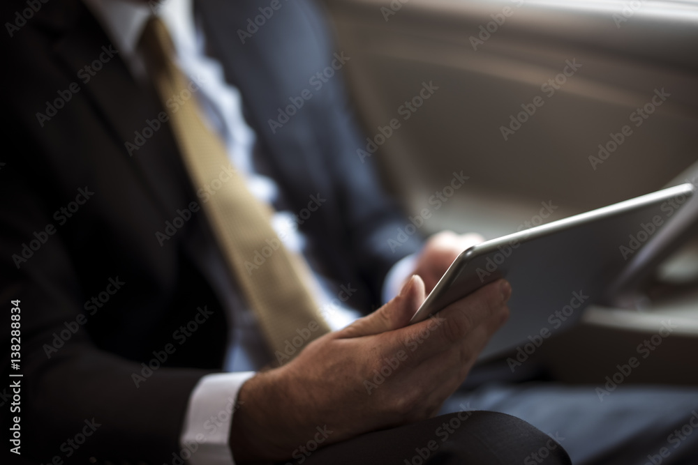 Businessman Using Tablet Working Car Inside