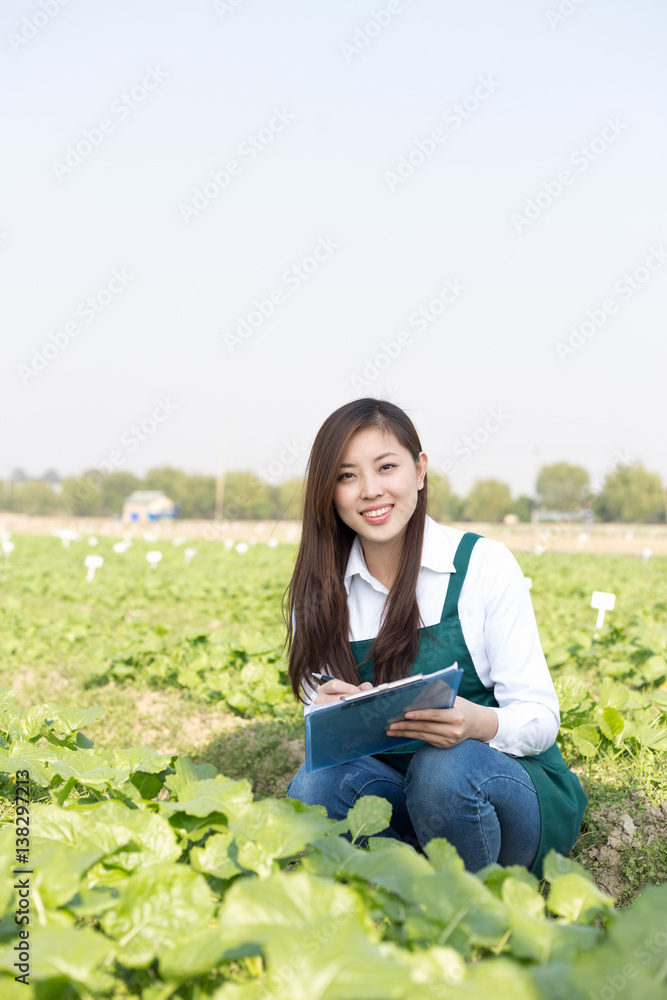 young asian woman in green vegetable field