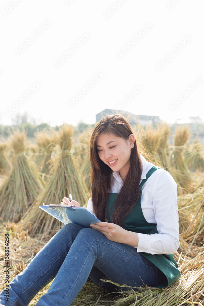 young asian woman in golden cereal field