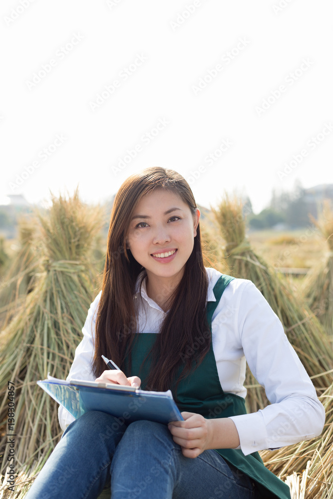 young asian woman in golden cereal field