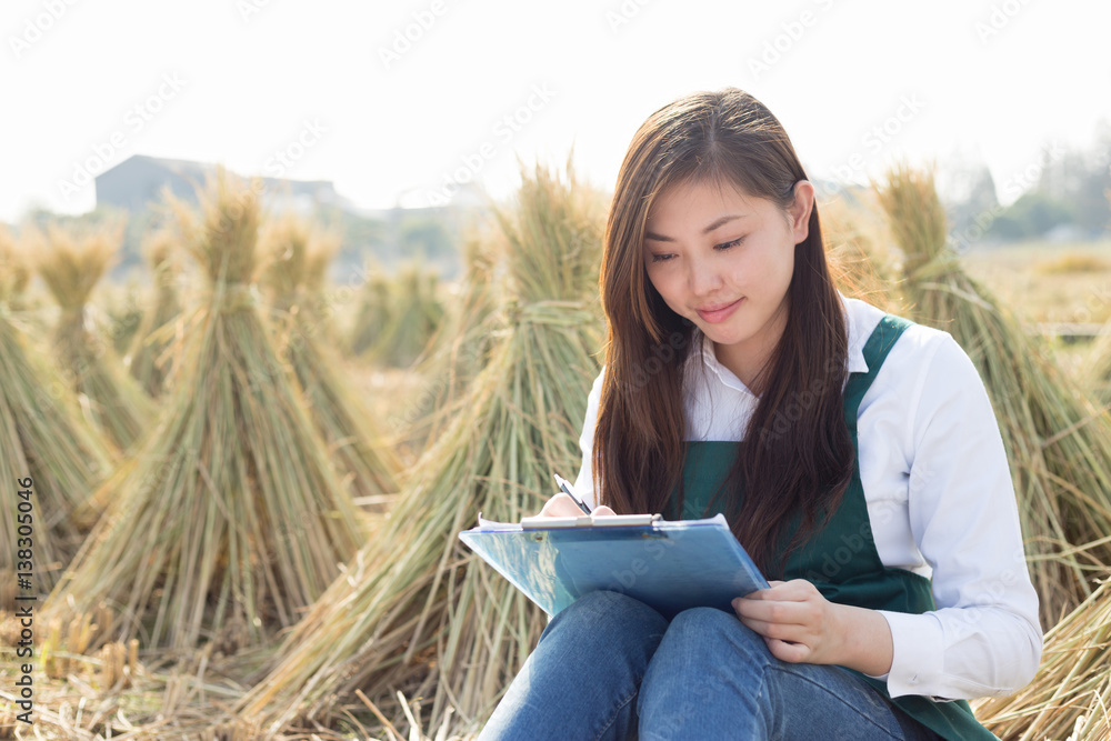 young asian woman in golden cereal field